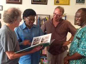 Left to Right: BFA founder Mr. Tom Warth, Dr. Veronica Ogbuagu, Dr. Patrick Plonski, and Mr. Atare Agbamu, looking at pictures of Dr. Ogbuagu's books distribution work in Delta, Edo, Osun, and Rivers states of Nigeria at BFA headquarters in St. Paul, Minnesota, USA 