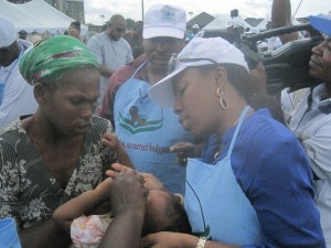 Mrs. Orezi Esievo Commissioner for Special Duties, (Directorate of Special Infrastructure), Delta State, giving immunization to one of the children during the flag-off polio eradication sensitization campaign   held at the Warri City Stadium