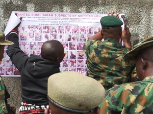 The Army pasting posters of the 100 most wanted Boko Haram terrorists in strategic locations around town