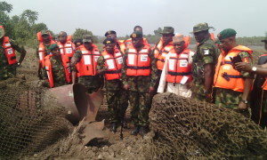 Minister of Defence, Brig-Gen Mansur Dan-Ali (4th right) with other top military officers assesing the damage of one of the facilities destroyed by yet to be identified militants at Egwa 11, Warri South West Local Government Area of Delta State.