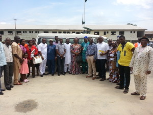 The class of 1988 in  a group photograph with some staff of Federal Government College, Warri. Behind them is the bus.