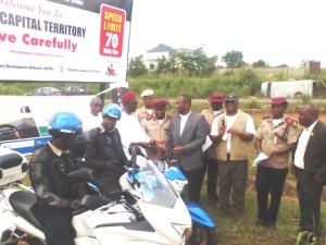 The community Engagement Co-ordinator of Chevron Nigeria Limited, Mr. Charles Egbuedo, handing over the keys of the Police Motor Bikes to Chief Clement Ofuani.