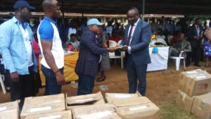 Surveyor Peter Akarogbe, President, Oyede Development Union (ODU), handing over the free text books to the Chief Inspector of Education, Isoko North local government council, Mr Solomon Oyenenue, yesterday. 