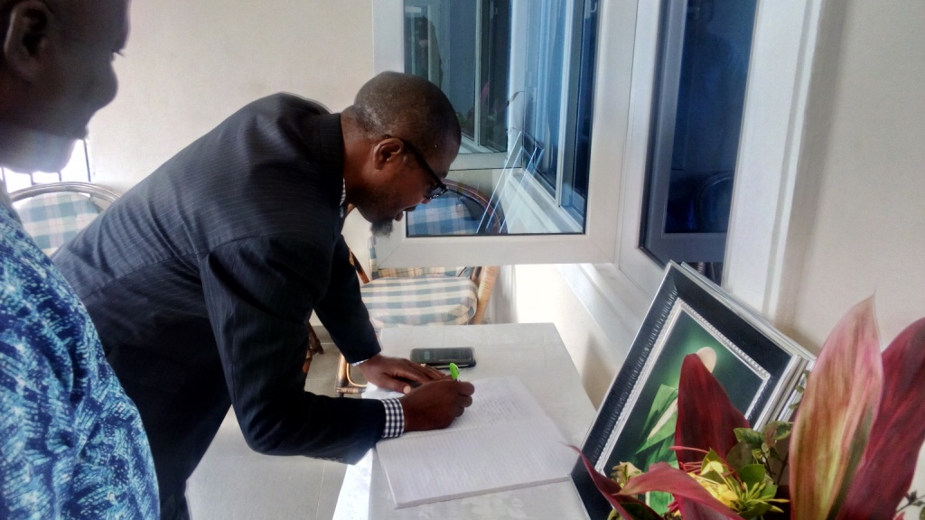 ESV Efe Appih, Chairman, NIESV, Delta State chapter, signing the condolence register when the paid the family of late ESV Ben Apkoriaye's family a condolence visit in Warri, yesterday. 